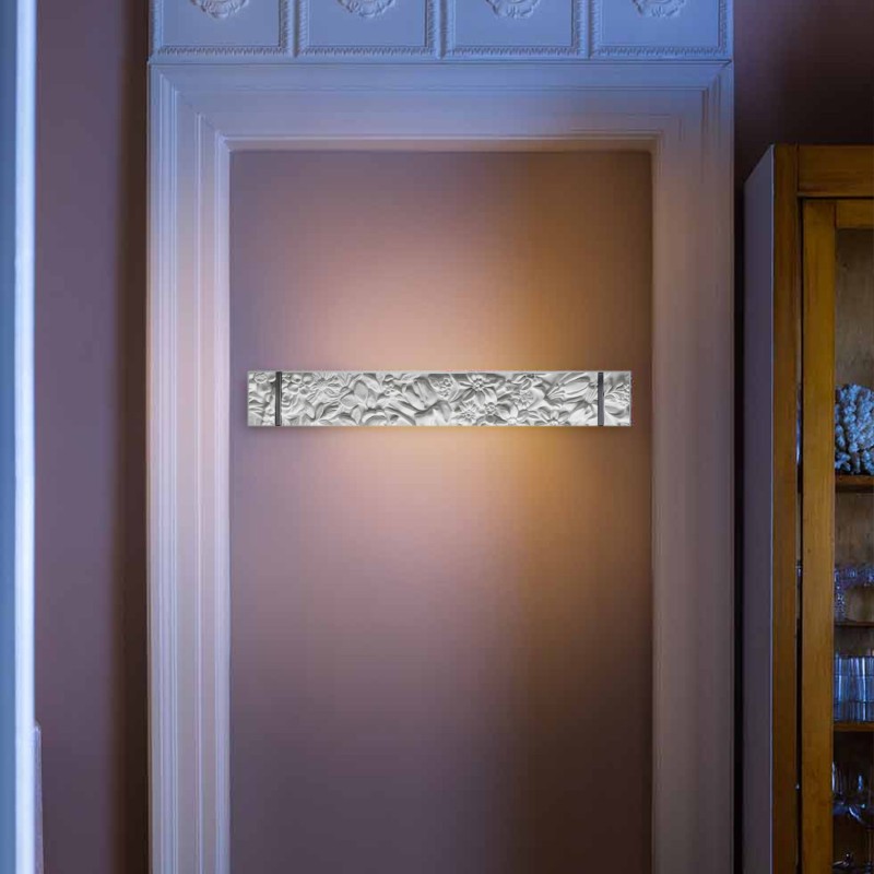 Decorative wall sconce on a wall with a textured finish