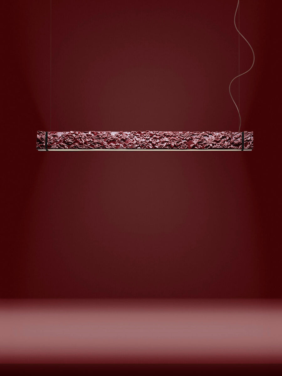 Decorative suspension light fixture on a dark red background