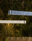 Two rectangular ceramic suspension lamp on a grassy surface