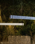 Two rectangular ceramic suspension lamp on a grassy surface