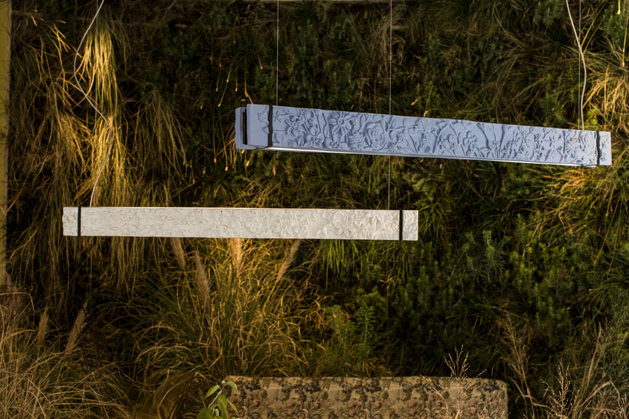 Two rectangular ceramic suspension lamp on a grassy surface