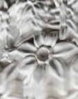 Close-up of white ceramic flowers of the Fregio lamp from Foscarini with a glossy finish 
