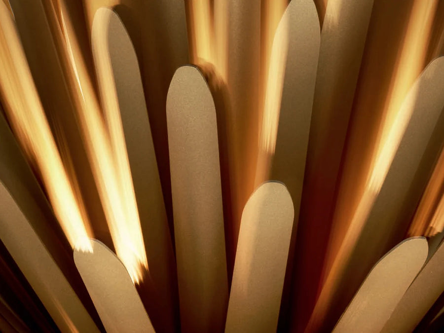 Close-up of Foscarini Sun light of love suspension lamp like a star burst in golden finish available at Spacio retail stores in Mumbai & Kolkata. 
