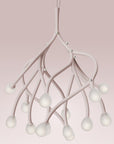 Modern chandelier with white branches on a pink background