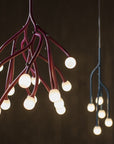 Modern chandelier with multiple light bulbs on a dark background