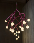 Modern chandelier with multiple light bulbs on a dark background