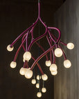 Modern chandelier with multiple light bulbs on a dark background