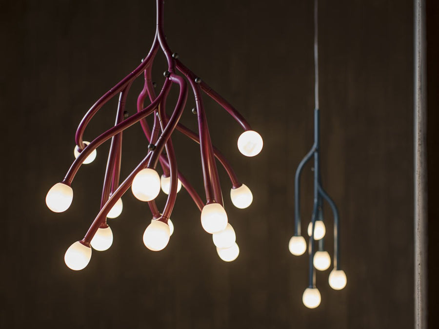 Modern chandelier with multiple light bulbs on a dark background