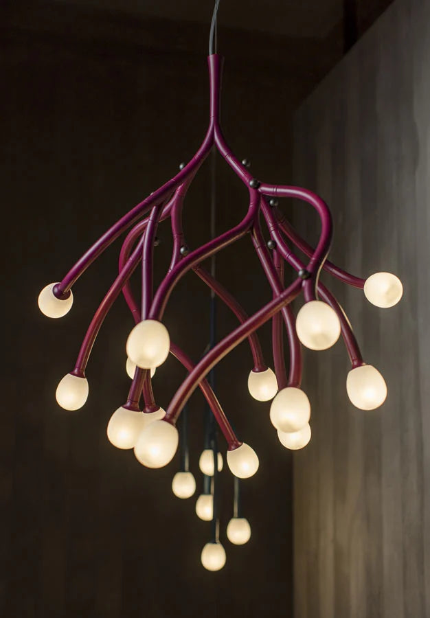 Modern chandelier with multiple light bulbs on a dark background