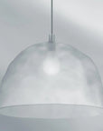 Silver pendant light against a gray background