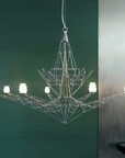 Modern chandelier with geometric design on a green wall