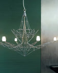 Modern chandelier with geometric design on a green wall