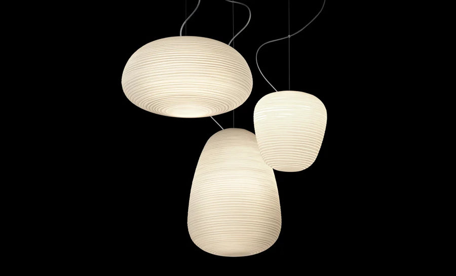 Three pendant lights with a textured design on a black background