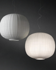 Two spherical pendant lights with a ribbed texture on a dark background