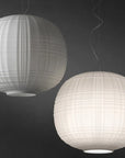 Two spherical pendant lights with a ribbed texture on a dark background
