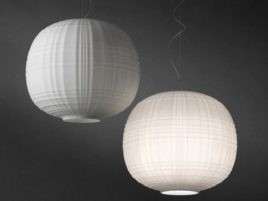 Two spherical pendant lights with a ribbed texture on a dark background
