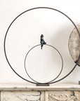 A Gardeco Bronze Sculpture Lost in Thoughts (Limited Edition) of a bird sitting on a circle, created using the lost wax method.