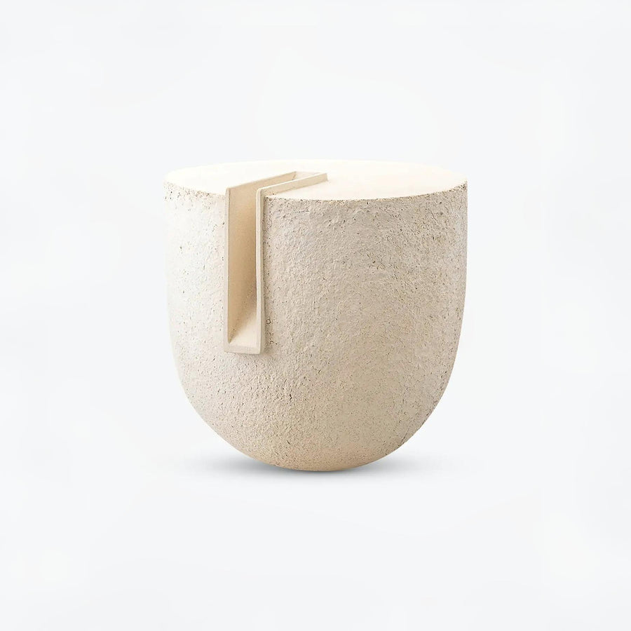 Beige ceramic sculpture Clausa Forma from Gardeco with a small rectangular opening on a white background available at Spacio retail stores in Mumbai & Kolkata