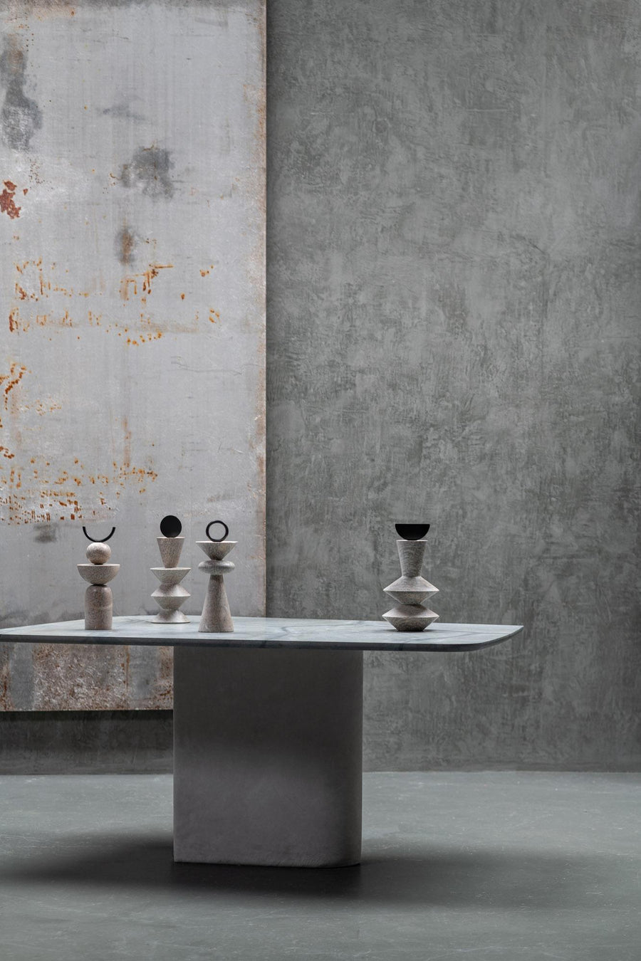 Table with soap stone sculptures against a textured wall