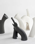 Four Gardeco Ceramic Sculpture Darius Black figurines of cats on a white surface.