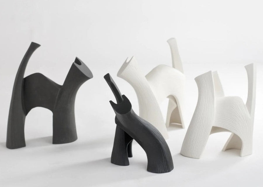 Four Gardeco Ceramic Sculpture Darius Black figurines of cats on a white surface.