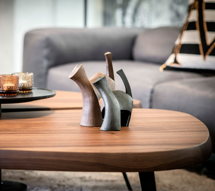 A coffee table adorned with a beautiful Gardeco Ceramic Sculpture Darius Brown vase.