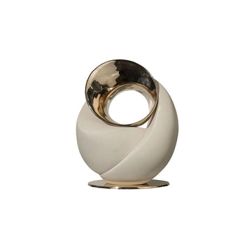 Decorative sculpture with gold and white design on a white background