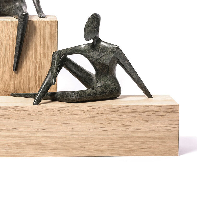 Abstract sculpture on a wooden block with a white background