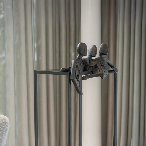 Decorative sculpture of three figures on a stand against a neutral background called Let's Talk by Gardeco