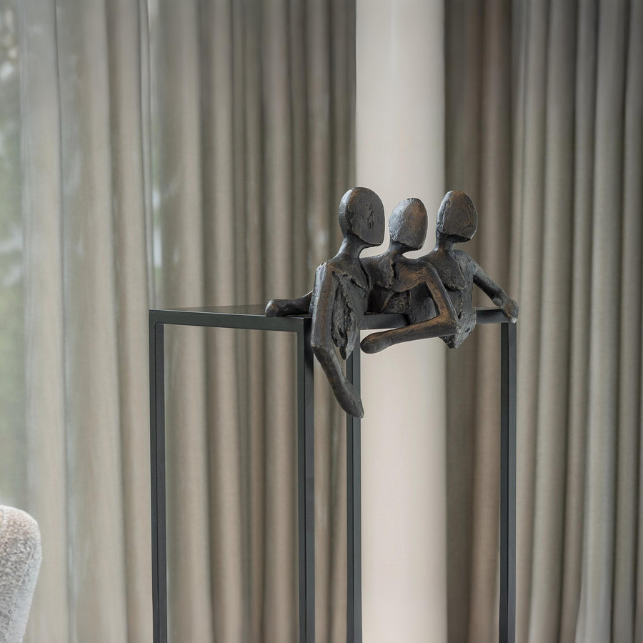 Decorative sculpture of three figures on a stand against a neutral background called Let's Talk by Gardeco