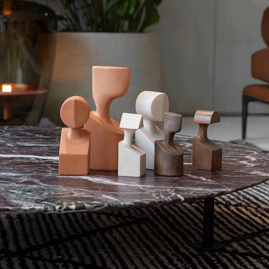 A coffee table adorned with intricate vases featuring the Gardeco Ceramic Sculpture The Muses Large Urania Ochre collection.