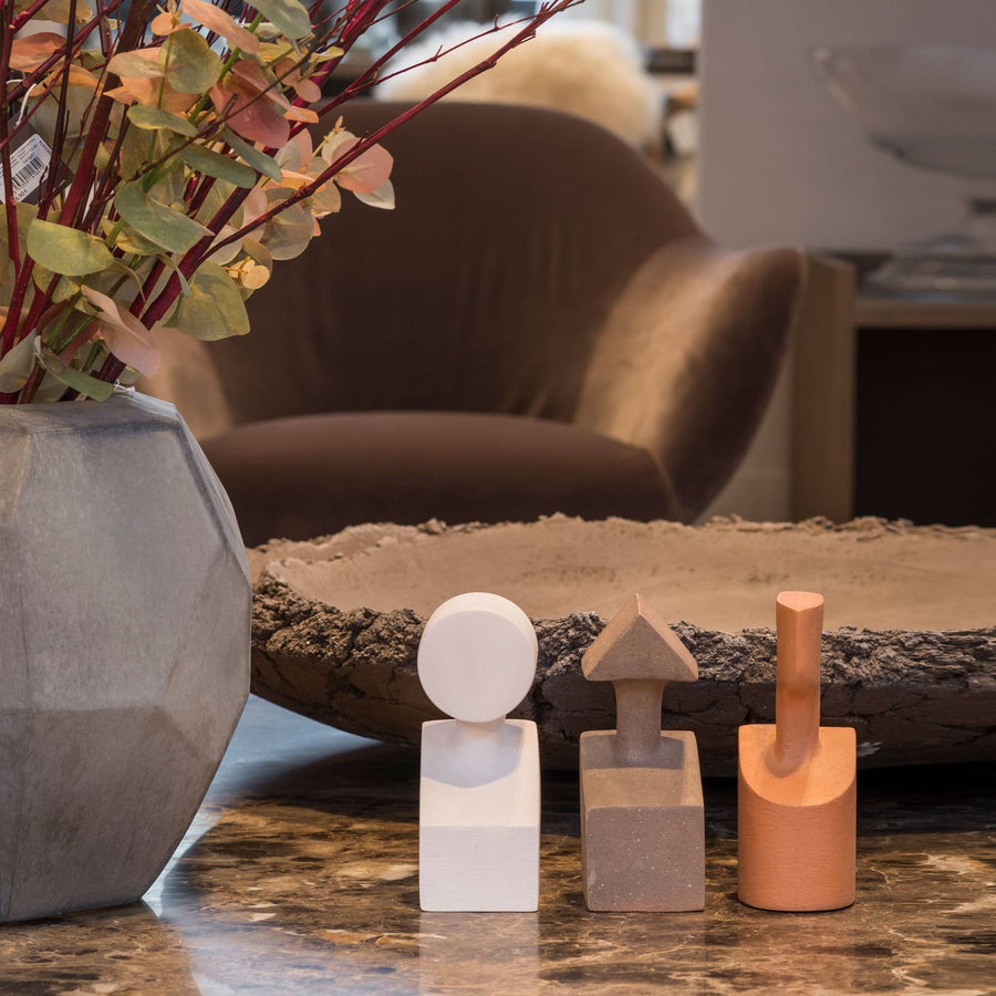 A Gardeco Ceramic Sculpture The Muses Large Urania Ochre, one of the Muses, sits on a table in a living room.