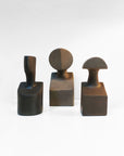 A group of Gardeco Ceramic Sculpture The Muses Plus Urania Natural sculptures, featuring black and brown objects.