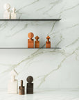 A white marble shelf with Gardeco Ceramic Sculpture The Muses Small Calliope Ochre figurines representing Muses from Greek mythology.