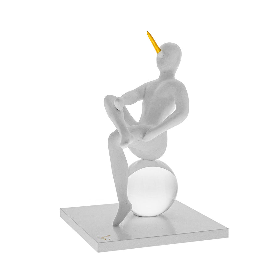 Abstract sculpture of a figure on a sphere with a yellow element on a white background