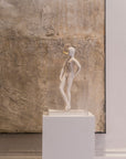 The Snob ceramic sculputre on a pedestal against a textured wall