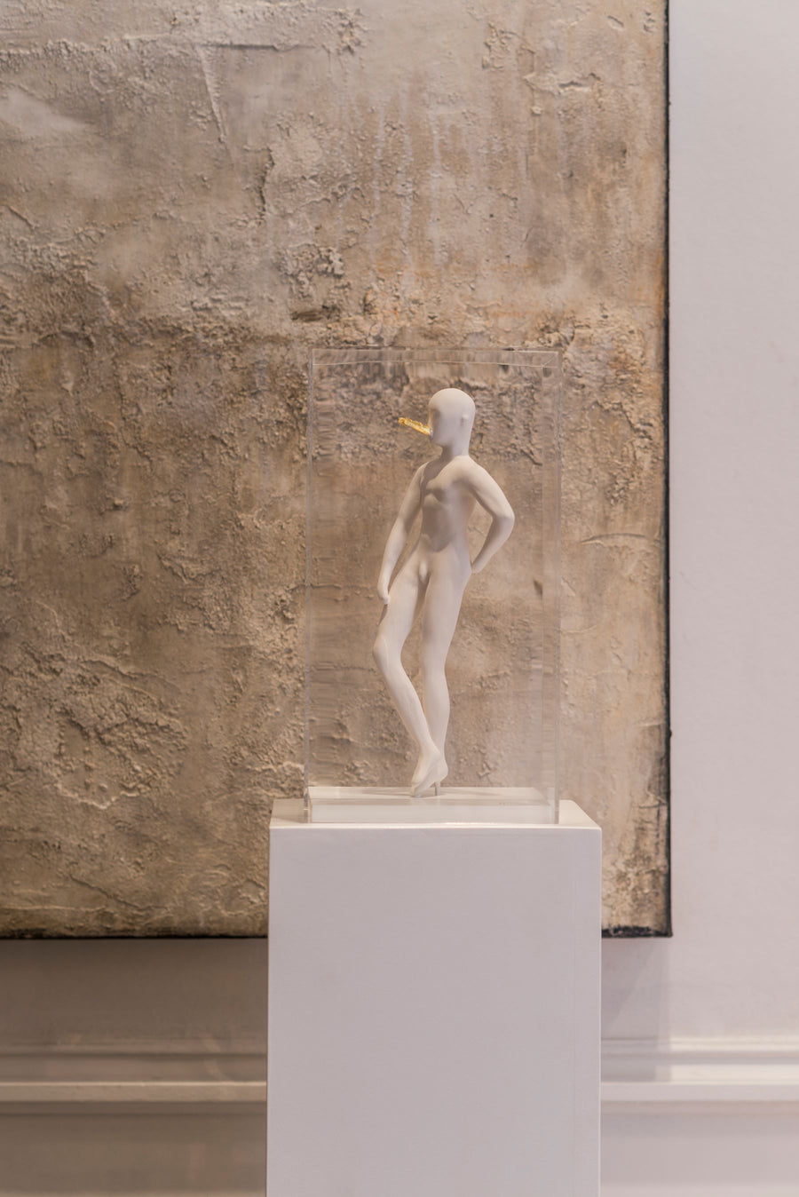 The Snob ceramic sculputre on a pedestal against a textured wall