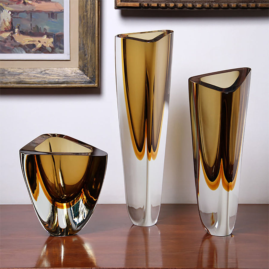 An elegant display of Gardeco Glass Vase Triangle 4 Fume Amber on a table.