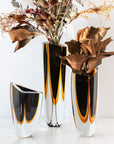 A Gardeco Glass Vase Triangle 1 Black Amber, showcasing contemporary refinement and a bicolour glass design.