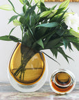 This description highlights the artisanal craftsmanship of a Gardeco Glass Vase 96 Fume Amber.