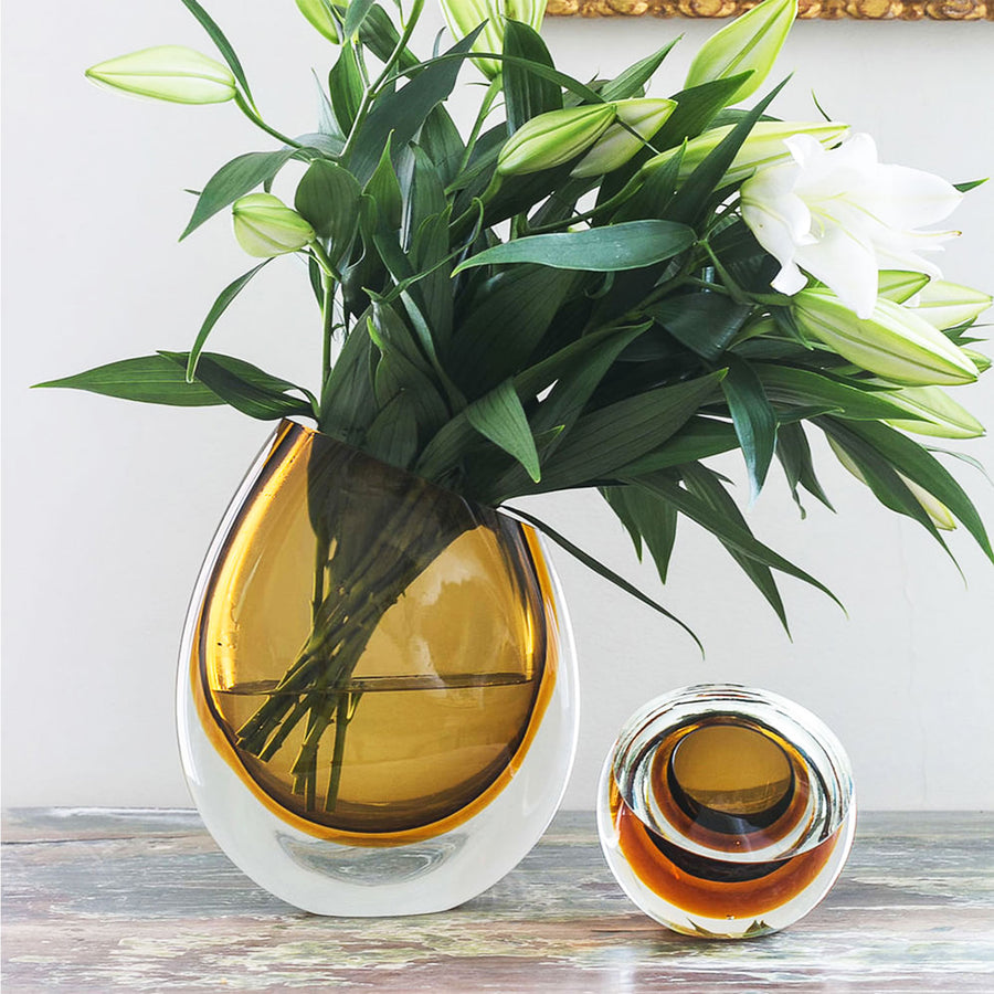 This description highlights the artisanal craftsmanship of a Gardeco Glass Vase 96 Fume Amber.