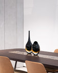 A versatile design of the Gardeco Glass Vase Drop Large Black Amber, beautifully displayed on a table.