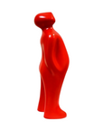 Red ceramic sculpture of a standing person on a white background