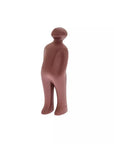 Brown ceramic figure of a person on a white background