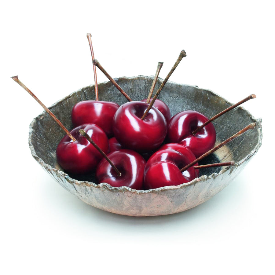 Decorative Gardeco ceramic sculpture of cherries in a bowl on a white background.