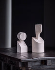 Two Gardeco Ceramic Sculpture The Muses Plus Clio White vases adorned with a white finish, sitting gracefully on a table.