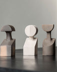 Three Gardeco Ceramic Sculpture The Muses Plus Clio White figurines in a White finish sitting on top of a table.