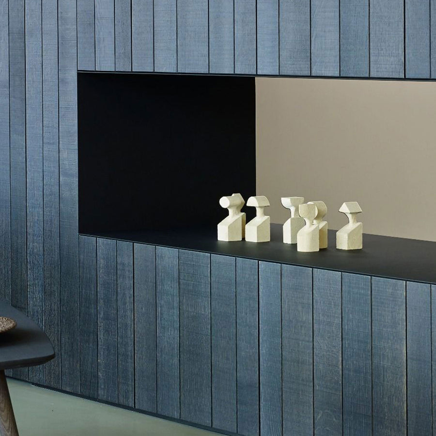 A room with a blue wall and a wooden shelf adorned with a Gardeco Ceramic Sculpture The Muses Plus Clio White.