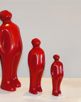 Three Gardeco Ceramic Sculpture Visitor Small Red Urucum, standing next to each other as an exceptional art display.