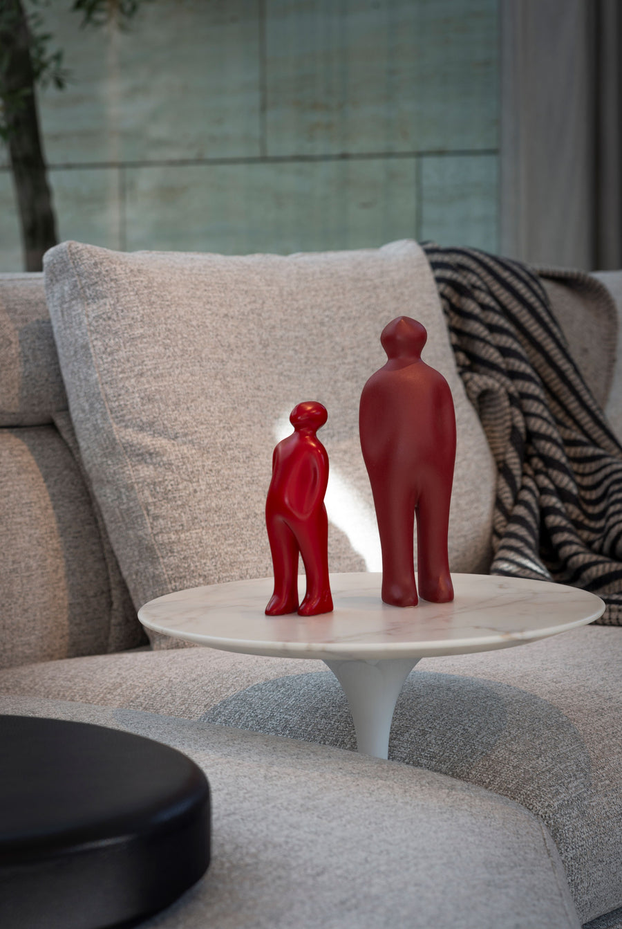 An art sculpture called "Gardeco Ceramic Sculpture Visitor Small Red Urucum" featuring two red figurines on a table.